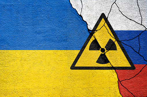 Flag of Ukraine and Russia painted on wall. Russian and ukrainian war. Zaporizhzhia Nuclear Power Plant