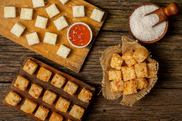 istock Raw and fried tapioca cubes (Dadinhos de Tapioca) on top of rustic wooden table 1507744441