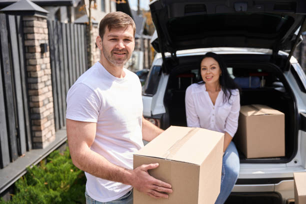istock Woman sitting in car trunk next to box 1507782576