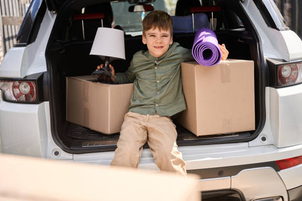 istock Child looks at the camera while sitting in the trunk 1507782596