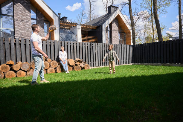 Caucasian man spending time with a child near his private house