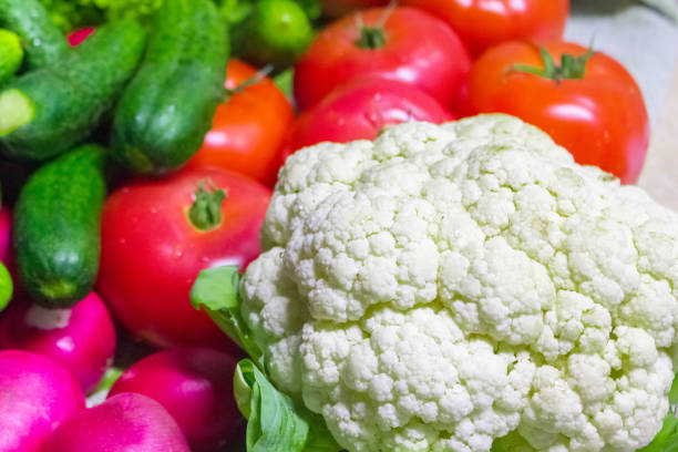 Cauliflower, tomatoes, cucumbers and radishes close-up.