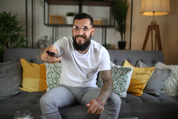 istock Relaxed man watching TV at home, copy space stock photo 1507920802