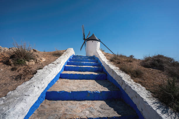 Consuegra, Spain - Mar 28, 2019: Blue and White Steps and Espartero Windmill - Consuegra, Castilla-La Mancha, Spain