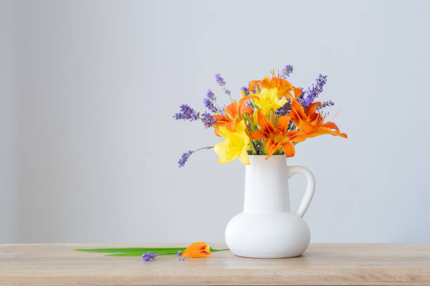 istock summer flowers in white jug on wooden shelf 1507968678