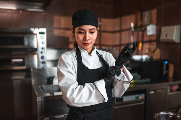 istock Mature Asian Chef Wears Gloves in Kitchen 1507973759