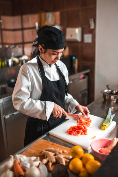 istock Putting Together Veggies, Female Chef in Kitchen 1507973761