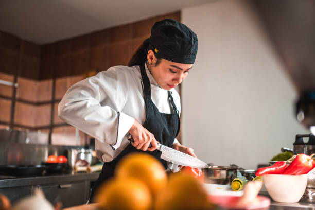 istock Female Chef Prepares Red Peppers with Care 1507973763