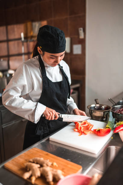 istock Asian Female Chef is Prepping Vegetables with a Knife 1507974786