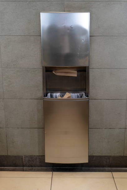 paper dispenser and waste basket in a public restroom - wiping feet imagens e fotografias de stock