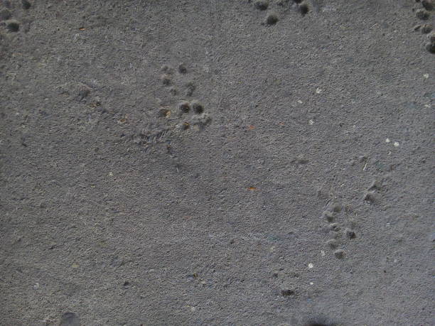 Textured Surface Of A Rough Concrete Wall With Uneven Plaster And Natural Imperfections, Ideal For Industrial Backgrounds.