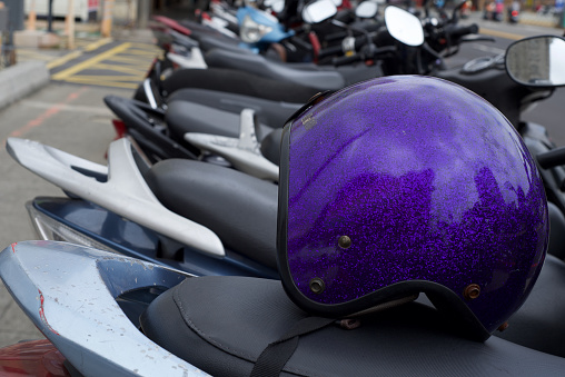 purple helmet on a scooter seat