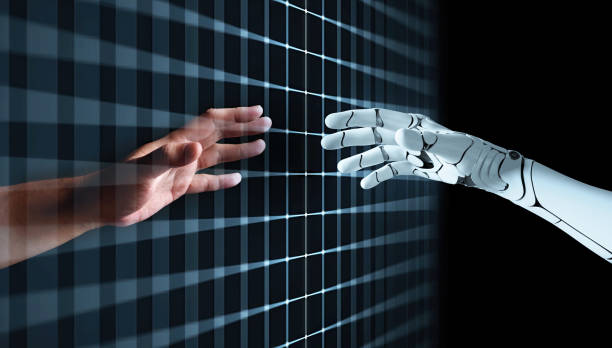 Hands of Robot and Human Touching together through computer moniter screen in dark background. Virtual Reality Augmented reality Artificial Intelligence technology digital twin driven smart concept stock photo
