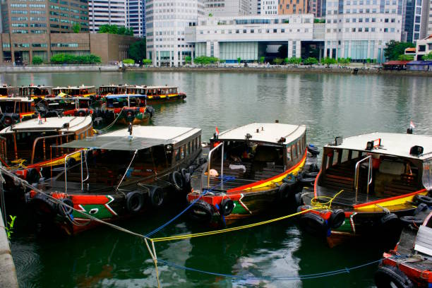 View along Bunruang Watergate canal in Bangkok into direction East from Thanon Asok. In background at one office buildingis company name Ital Thai for construction