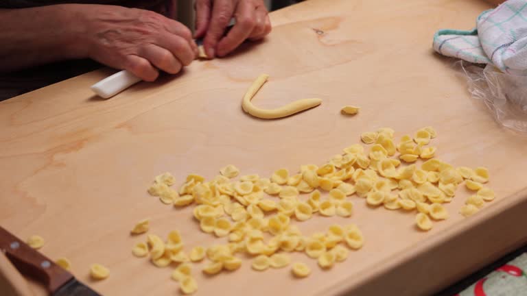 Lady Making fresh orecchiette Bari old town, Apulia