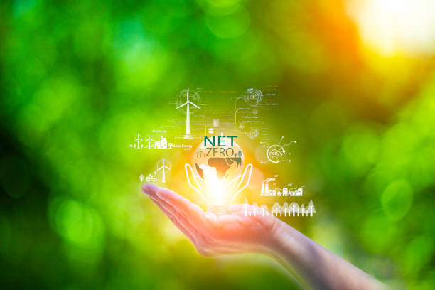 istock net zero concept. Hand holding bulb with net zero icon. carbon neutral concept. Dusty city environment PM 2.5 background. Climate-neutral long-term strategy. Carbon gas affects global warming 1508317756