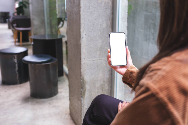 istock Mockup image of a woman holding and using mobile phone with blank desktop screen 1508318606