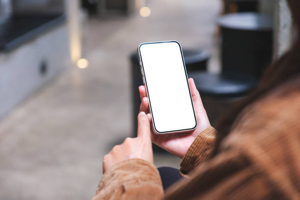 istock Mockup image of a woman holding and using mobile phone with blank desktop screen 1508318609