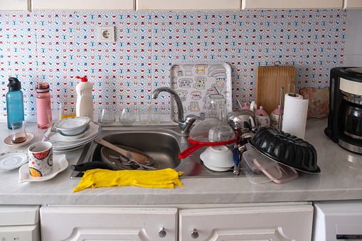 dirty and unwashed dishes in the kitchen sink. housecleaning.