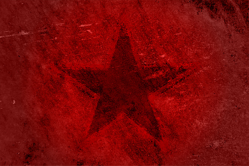 A solid maroon pentagram star outline over vibrant red coloured rustic weathered grunge uneven background and empty or blank space all around. Apt for Greeting cards, backdrops, banners or posters with copy space for text.