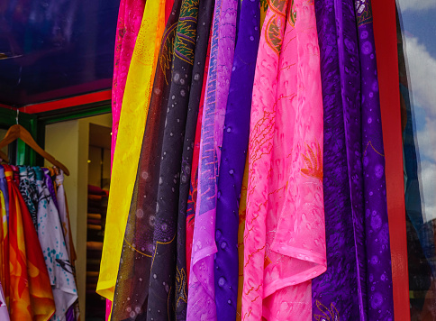 Colorful shawls for sale at fashion store in Central Market of Port Louis, Mauritius.