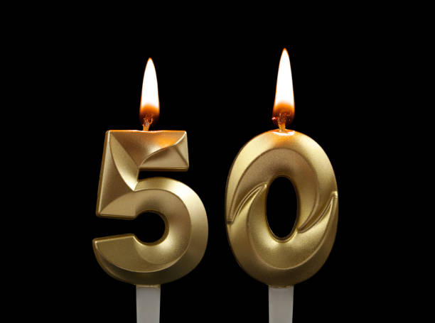 istock Gold birthday candles isolated on black, number 50 1508412952
