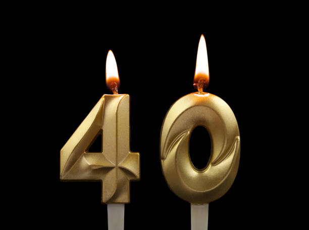 Gold birthday candles isolated on black, number 40 stock photo