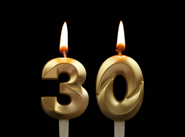 istock Gold birthday candles isolated on black, number 30 1508413480