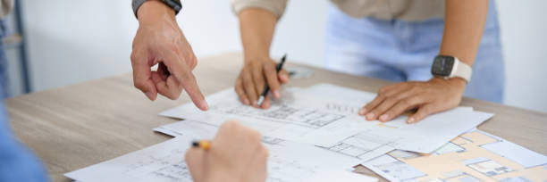 istock Engineering construction concept, Engineers team point blueprint of building to discussing together 1508439213