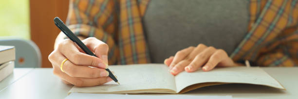 istock Education and literacy concept, College student girl read lesson sheet and take notes on notebook 1508450577