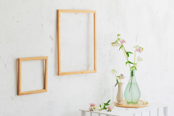 istock flowers in vase and wooden frames on white interior 1508479489