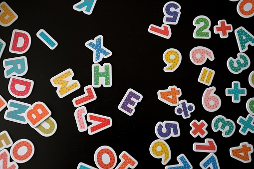 Top view of numbers and letters against black background