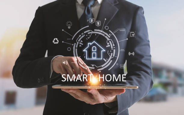 istock Hands using Smart home control on tablet. Interior of living room in the background. 1508540353