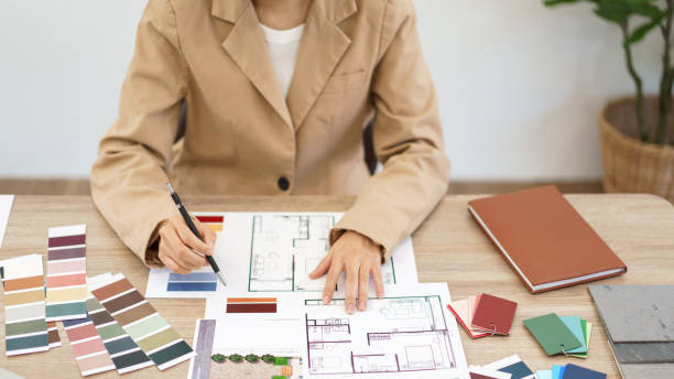 istock Architecture concept, Female architect selecting color and designing house interior in blueprint 1508565105