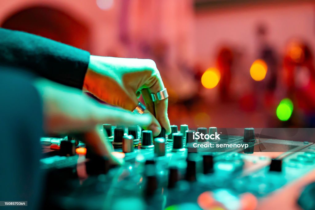 woman DJ Hands creating and regulating music on dj console mixer in concert DJ Stock Photo