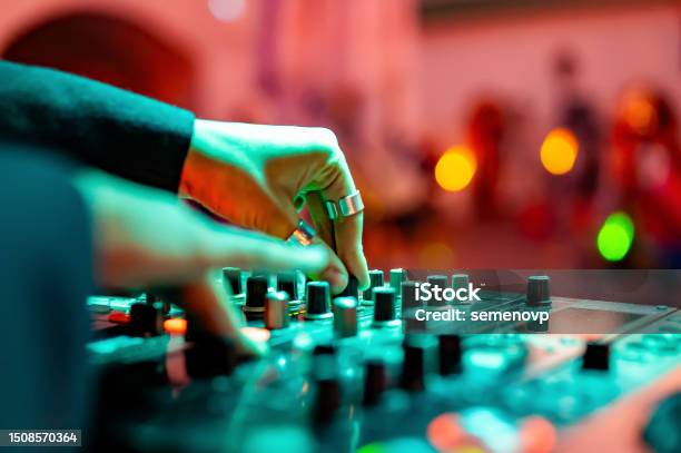 Woman Dj Hands Creating And Regulating Music On Dj Console Mixer In Concert Stock Photo - Download Image Now