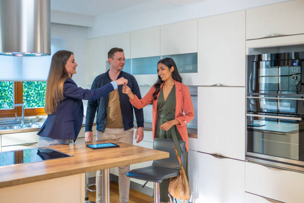 istock Real estate agent giving  key to couple 1508589869