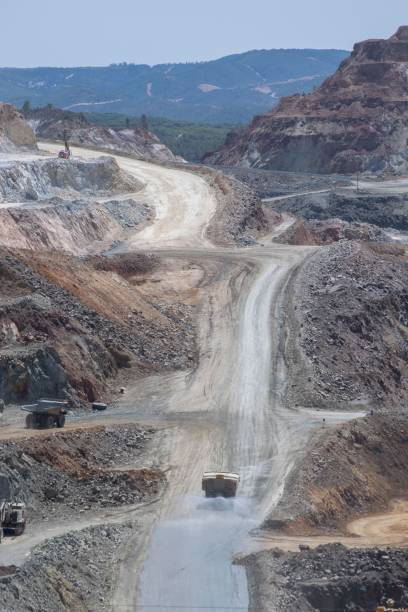 istock Vertical of a off-road vehicles driving on a dirt road during an open-pit mining operation 1508599571