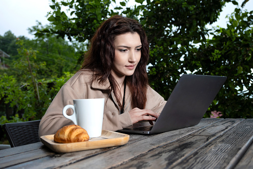 Woman working on laptop in cafe