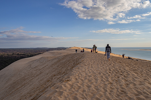 People walking on the Dune of Pilat, the tallest sand dune in Europe on a sunny spring day