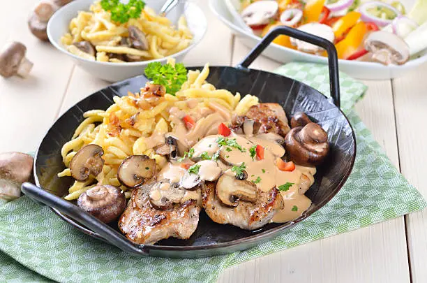 Escalope of pork with champignons, sauce and spaetzle