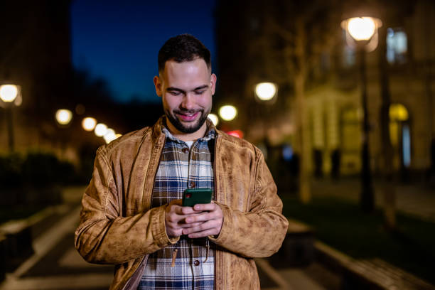 istock Young man walking down the street while using his phone 1508720271