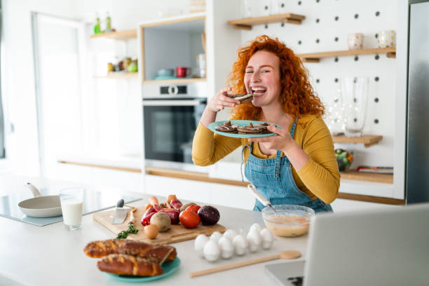 istock Woman looking at camera while having a cheat meal at home 1508744546