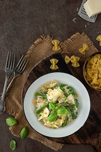 Asparagus and pea pasta on a rustic background