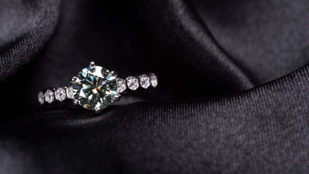 istock beautiful silver ring with diamond on a black background 1508775831