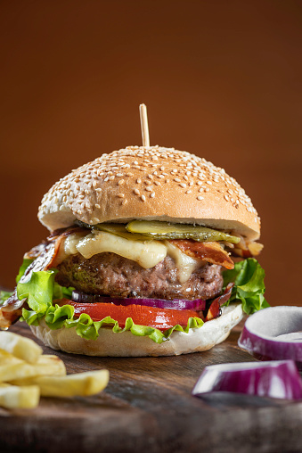 burgers with cutlet and french fries on black background