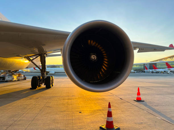 istock airplane engine is foreground airplane is in apron at sunset horizontal transportation still 1508792794