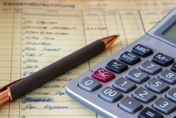 istock cash accounting book with calculator and pen 1508802997