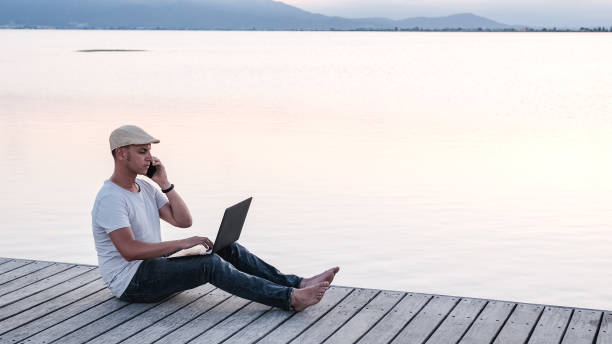 istock Male freelancer working on pier. Remote worker at sunset 1508826985