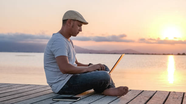 istock Male freelancer working on pier. Remote worker at sunset 1508827503